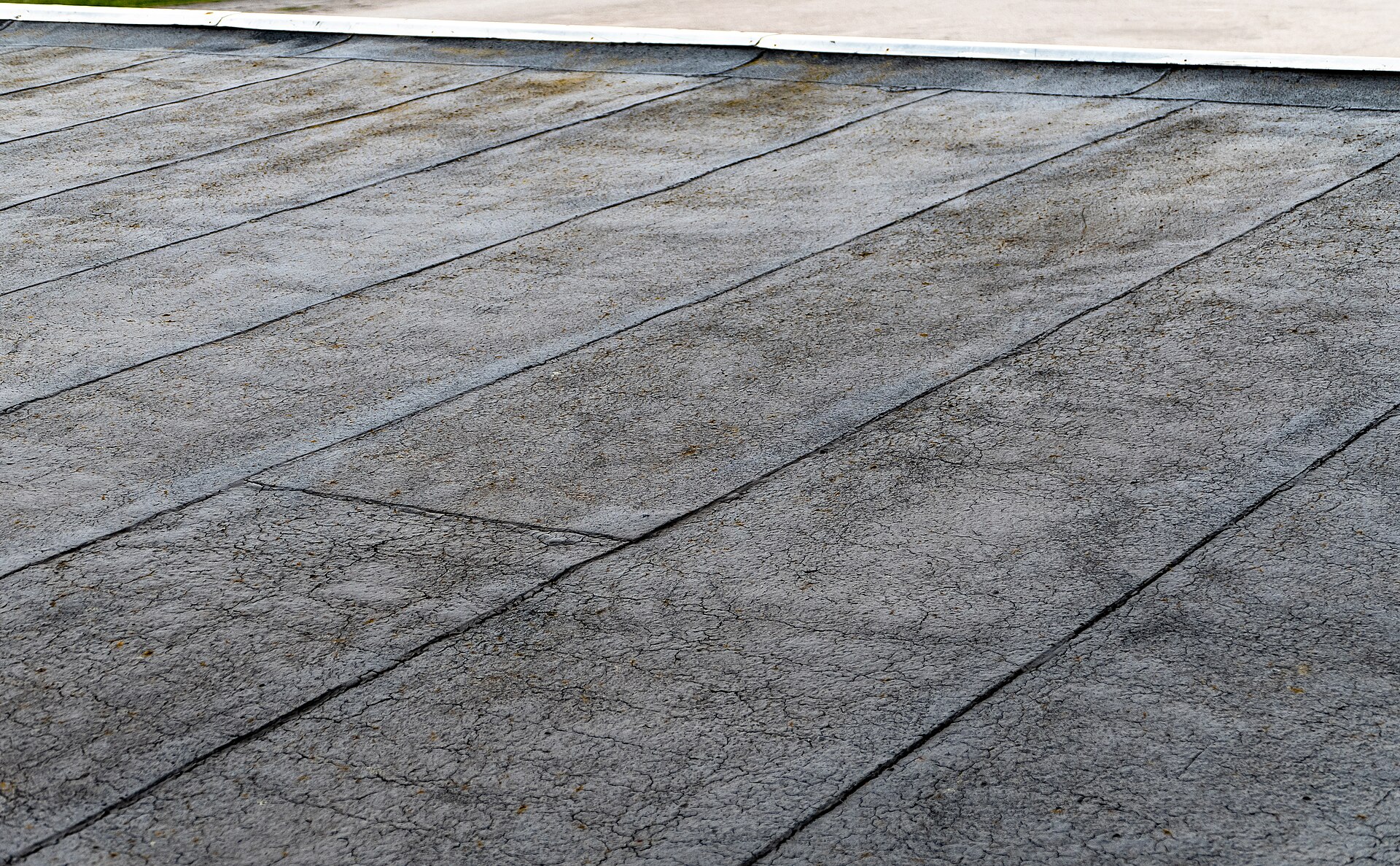 Weathered low-slope roof membrane with visible seams